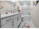 Well-lit bathroom features a double vanity with white countertop and cabinets, framed mirror, and a shower-tub combo at 2486 Buckthorn Loop, North Port, FL 34289
