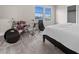 Bedroom with neutral colors and carpet flooring, features a musical drumset and natural light at 2486 Buckthorn Loop, North Port, FL 34289
