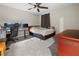 Bright bedroom featuring a ceiling fan, neutral paint, plush carpet, and a cozy ambiance perfect for relaxation at 2486 Buckthorn Loop, North Port, FL 34289