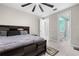 Well-lit bedroom with tile floors, a large bed, and access to an en-suite bathroom with modern features at 2486 Buckthorn Loop, North Port, FL 34289