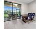 The dining area is adjacent to a large window providing natural light, a table, and seating for a comfortable meal at 2486 Buckthorn Loop, North Port, FL 34289