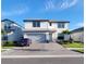 Beautiful two-story home with a brick driveway, two-car garage, and manicured landscaping at 2486 Buckthorn Loop, North Port, FL 34289