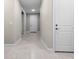 Bright hallway with tile flooring and neutral-toned walls, showcasing the interior design at 2486 Buckthorn Loop, North Port, FL 34289