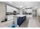 Spacious kitchen with white cabinets, stainless steel appliances, and a large center island at 2486 Buckthorn Loop, North Port, FL 34289