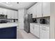 Modern kitchen showcasing white cabinetry, stainless steel appliances, quartz countertops, and tile backsplash at 2486 Buckthorn Loop, North Port, FL 34289