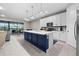Modern kitchen featuring white cabinets, stainless steel appliances, and a large island at 2486 Buckthorn Loop, North Port, FL 34289
