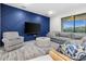 Comfortable living room with an accent wall, modern furnishings, and ample natural light from a large window at 2486 Buckthorn Loop, North Port, FL 34289
