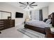 Serene bedroom featuring a dark wood bed frame, tiled floors, and soft lighting, creating a relaxing retreat at 2486 Buckthorn Loop, North Port, FL 34289