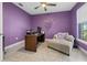 Stylish purple office with a ceiling fan, comfortable chaise lounge, and ample desk space at 2486 Buckthorn Loop, North Port, FL 34289