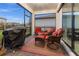 Covered patio featuring comfortable seating arrangements and a built-in grill perfect for outdoor entertaining at 2486 Buckthorn Loop, North Port, FL 34289
