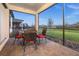 Inviting patio with brick pavers and outdoor dining set, perfect for enjoying the backyard and lake view at 2486 Buckthorn Loop, North Port, FL 34289