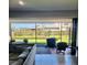 View of an outdoor patio with tile flooring, furniture and a scenic view of the lawn and neighborhood at 2486 Buckthorn Loop, North Port, FL 34289