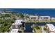 Aerial view of the community with waterfront access, boat docks, tennis courts, and lush greenery at 25188 Marion Ave # D303, Punta Gorda, FL 33950