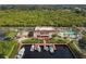 Aerial view of waterfront community featuring a pool, boat docks, and lush surroundings at 25188 Marion Ave # D303, Punta Gorda, FL 33950