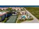 Aerial view showcasing the community pool, tennis courts, boat docks, and waterways at 25188 Marion Ave # D303, Punta Gorda, FL 33950