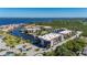 Stunning aerial view of waterfront condos with boat docks, lush landscaping, and beautiful bay views at 25188 Marion Ave # D303, Punta Gorda, FL 33950