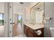 Bathroom with wood vanity and views of balcony at 25188 Marion Ave # D303, Punta Gorda, FL 33950