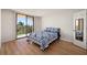 Bright bedroom with a bed, balcony access, and plenty of natural light at 25188 Marion Ave # D303, Punta Gorda, FL 33950