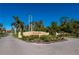Community entrance sign surrounded by lush landscaping and palm trees at 25188 Marion Ave # D303, Punta Gorda, FL 33950