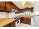 Efficient kitchen with ample wooden cabinetry, white appliances and a bright, airy feel at 25188 Marion Ave # D303, Punta Gorda, FL 33950