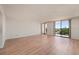 Spacious living room with laminate flooring and sliding glass doors opening to a beautiful outdoor view at 25188 Marion Ave # D303, Punta Gorda, FL 33950
