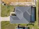 Aerial view showing home's screened-in pool, landscaping, roof, and the surrounding property at 260 Long Meadow Ln, Rotonda West, FL 33947
