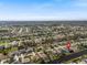 Expansive aerial view of a residential community with waterfront homes, landscaping, and serene canals at 260 Long Meadow Ln, Rotonda West, FL 33947