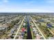 Aerial view of a waterfront community featuring a canal running through residential neighborhoods and lush greenery at 260 Long Meadow Ln, Rotonda West, FL 33947