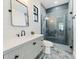 Modern bathroom with stylish tiling, sleek vanity, and a glass-enclosed walk-in shower at 260 Long Meadow Ln, Rotonda West, FL 33947