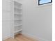 Walk-in closet featuring a built-in storage unit with a series of adjustable shelves at 260 Long Meadow Ln, Rotonda West, FL 33947