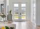 Elegant entryway with frosted glass doors, modern decor, and bright, welcoming atmosphere at 260 Long Meadow Ln, Rotonda West, FL 33947
