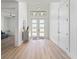 Bright foyer with a modern front door, decorative light fixture, and sleek flooring for a grand entrance at 260 Long Meadow Ln, Rotonda West, FL 33947