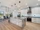 Bright modern kitchen featuring a spacious island, stainless steel appliances, and beautiful views of the backyard at 260 Long Meadow Ln, Rotonda West, FL 33947