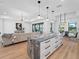 Open-concept layout showcases the kitchen island with seating, seamlessly connecting to the living and dining areas at 260 Long Meadow Ln, Rotonda West, FL 33947