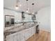 Modern kitchen with sleek cabinetry, granite countertops, stainless steel appliances, and stylish pendant lighting at 260 Long Meadow Ln, Rotonda West, FL 33947