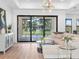 Cozy living room featuring a comfortable sectional sofa, contemporary decor, and sliding glass doors to pool at 260 Long Meadow Ln, Rotonda West, FL 33947