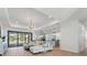 Bright, open-concept living room with modern lighting, expansive windows, and beautiful flooring at 260 Long Meadow Ln, Rotonda West, FL 33947