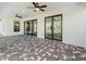 Back patio featuring stylish brick pavers, ceiling fans, and large sliding glass doors that lead to the refreshing in-ground pool at 260 Long Meadow Ln, Rotonda West, FL 33947