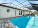 A clear blue in-ground pool enclosed by a screened-in patio, perfect for year-round enjoyment and outdoor living at 260 Long Meadow Ln, Rotonda West, FL 33947