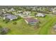 Aerial view of a home featuring a screened-in pool, surrounded by a well-maintained lawn and lush landscaping at 26389 Villa Maria Dr, Punta Gorda, FL 33983
