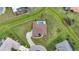 Aerial view of a home with a circular driveway and a screened-in pool in a beautifully landscaped neighborhood at 26389 Villa Maria Dr, Punta Gorda, FL 33983