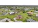 Aerial view of a beautiful community showcasing the house with a pool and carefully manicured green spaces at 26389 Villa Maria Dr, Punta Gorda, FL 33983