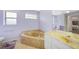 Comfortable bathroom with a corner tub, single vanity, and a view into the bedroom at 26389 Villa Maria Dr, Punta Gorda, FL 33983