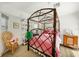 Bedroom displays a unique bed, a wicker chair and display shelving at 26389 Villa Maria Dr, Punta Gorda, FL 33983