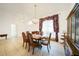 Bright dining room with elegant chandelier and tiled floor, perfect for gatherings at 26389 Villa Maria Dr, Punta Gorda, FL 33983