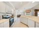 Spacious kitchen with white cabinetry and countertops, and a seamless flow to adjacent spaces at 26389 Villa Maria Dr, Punta Gorda, FL 33983