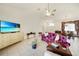 Cozy living room featuring a vaulted ceiling, tiled flooring and comfortable seating at 26389 Villa Maria Dr, Punta Gorda, FL 33983