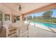 Inviting outdoor patio area with ample seating, overlooking the pool and beautifully landscaped backyard at 26389 Villa Maria Dr, Punta Gorda, FL 33983