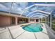 Backyard pool with a screened in lanai and patio area at 26389 Villa Maria Dr, Punta Gorda, FL 33983