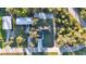 An aerial shot of a single Gathering home with a well manicured lawn, and a lengthy driveway at 267 Camrose St, Port Charlotte, FL 33954
